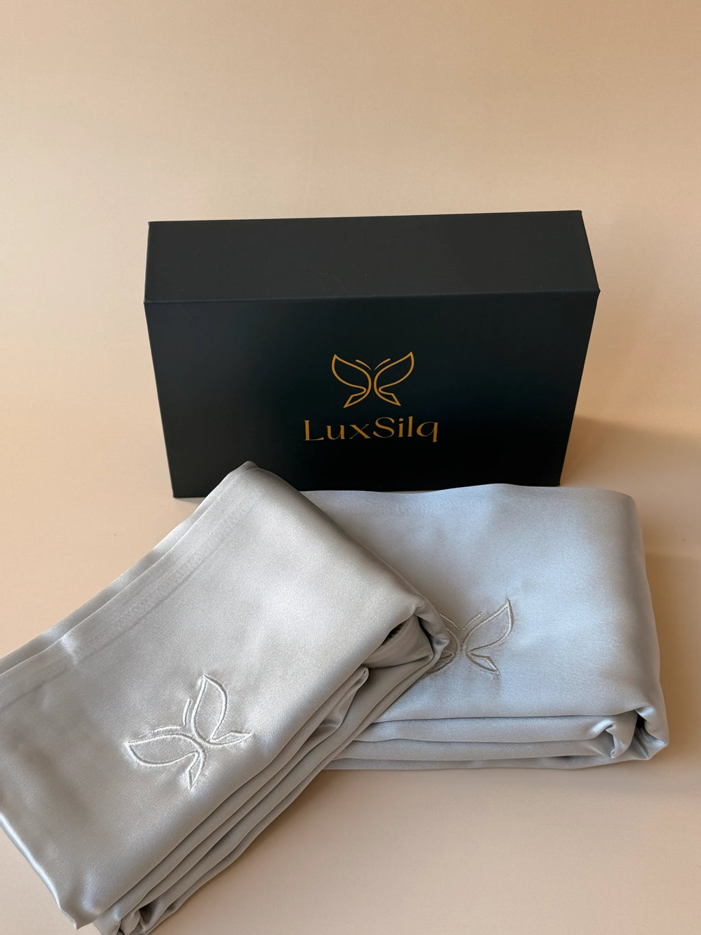 LuxSilq branded silk pillowcases with a black box on a beige background
moonlight